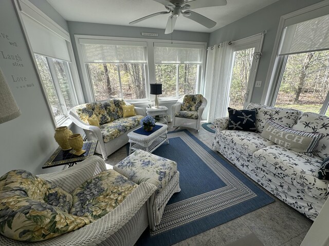 sunroom with ceiling fan and outdoor lounge area