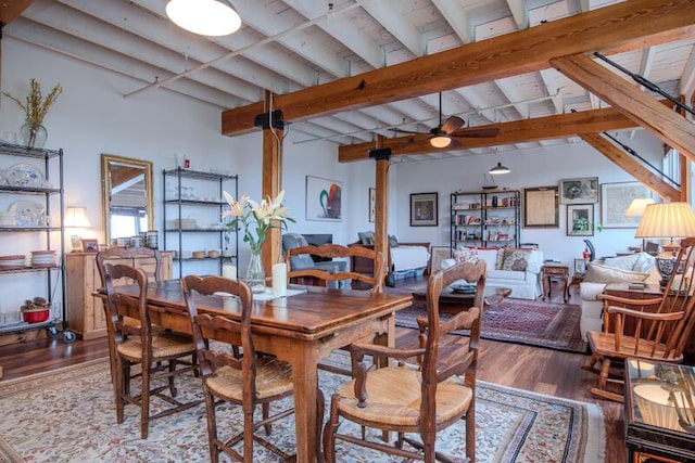 dining space featuring ceiling fan, beamed ceiling, high vaulted ceiling, and wood finished floors