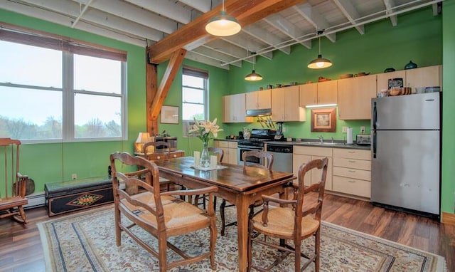 dining space with a high ceiling, dark wood-type flooring, and beam ceiling