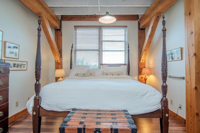 bedroom with baseboards and wood finished floors