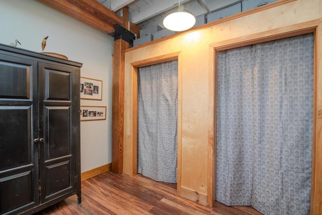 interior space with wood finished floors and baseboards