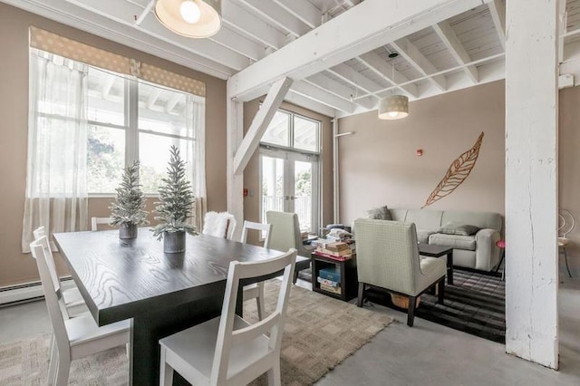 dining room featuring french doors and a baseboard heating unit
