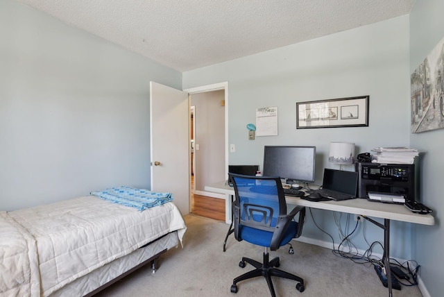 bedroom featuring baseboards, carpet flooring, and a textured ceiling