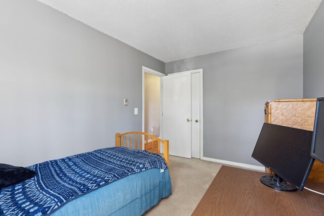 carpeted bedroom featuring baseboards