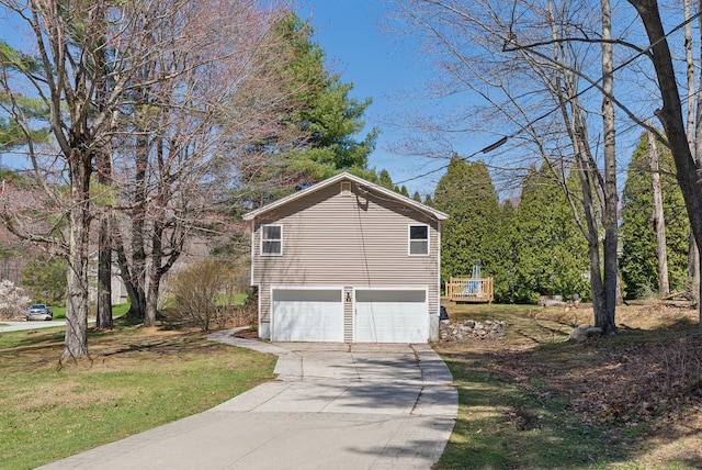 view of side of property featuring an attached garage and driveway
