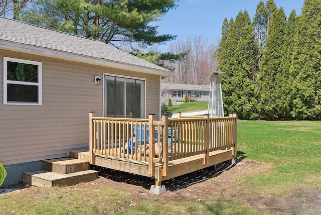 wooden deck featuring a yard
