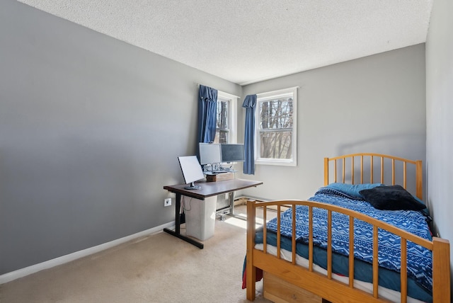 bedroom featuring carpet floors, a textured ceiling, and baseboards