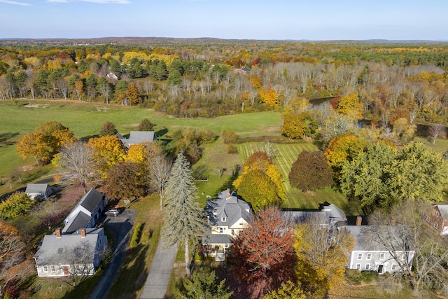 bird's eye view with a wooded view
