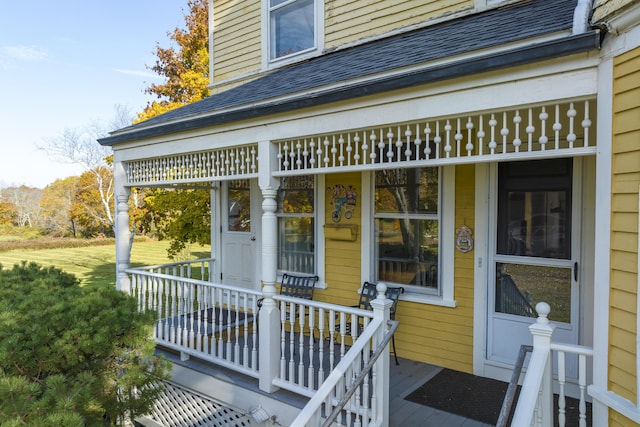 property entrance with roof with shingles