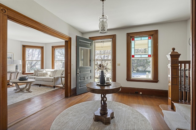 entrance foyer with baseboards and hardwood / wood-style floors