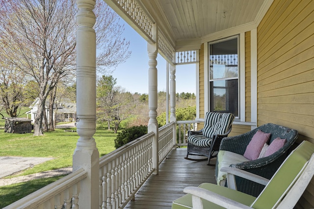 wooden deck with a yard and a porch