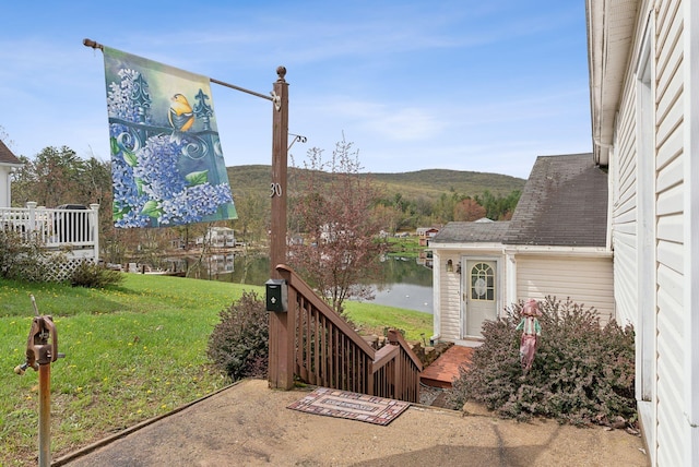30 Swan Cir, Shapleigh, ME 04076 - view of grassy yard featuring a deck with water view