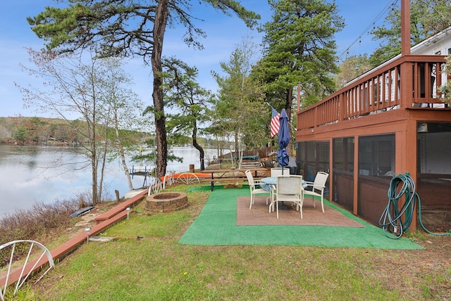 30 Swan Cir, Shapleigh, ME 04076 - view of grassy yard featuring a fire pit, a water view, and a patio area