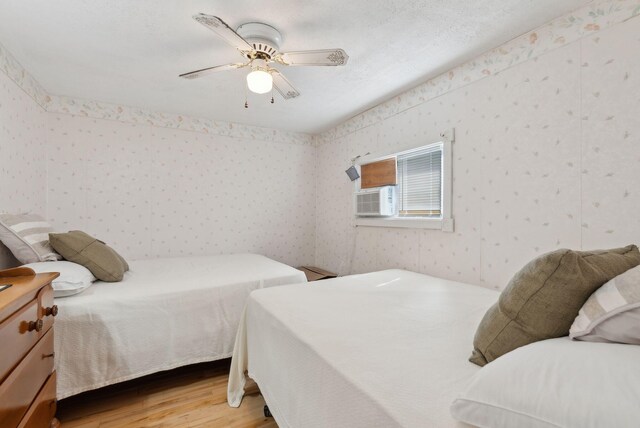 30 Swan Cir, Shapleigh, ME 04076 - bedroom featuring wallpapered walls, light wood finished floors, ceiling fan, and cooling unit