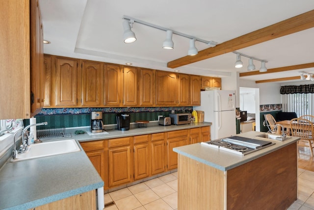 30 Swan Cir, Shapleigh, ME 04076 - kitchen with a sink, freestanding refrigerator, rail lighting, stovetop with downdraft, and light tile patterned flooring