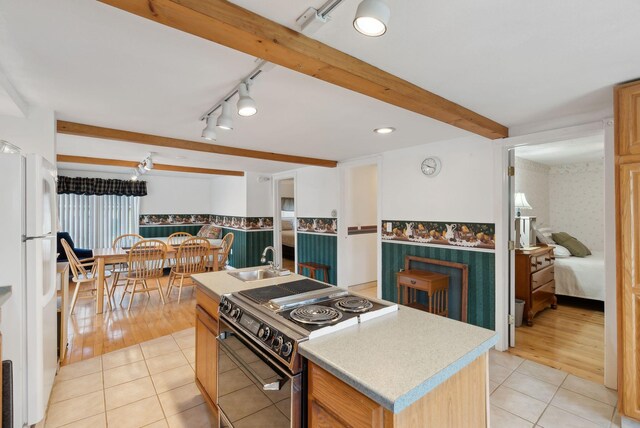30 Swan Cir, Shapleigh, ME 04076 - kitchen featuring black / electric stove, freestanding refrigerator, a sink, light tile patterned floors, and rail lighting