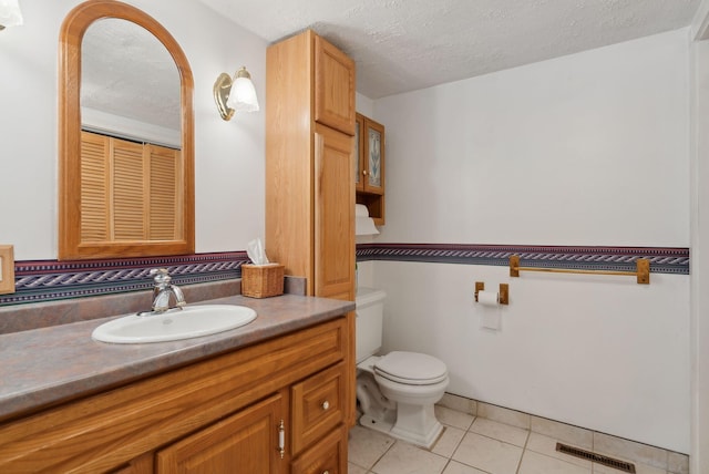 30 Swan Cir, Shapleigh, ME 04076 - bathroom with a textured ceiling, toilet, tile patterned flooring, and vanity