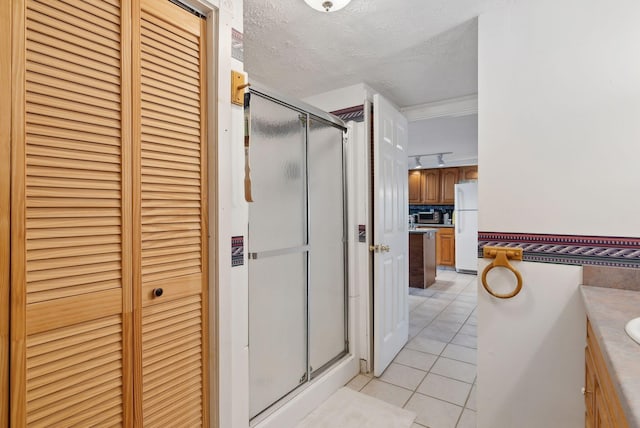 30 Swan Cir, Shapleigh, ME 04076 - bathroom with a closet, tile patterned floors, a shower stall, vanity, and a textured ceiling