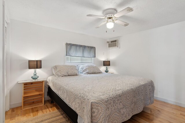 30 Swan Cir, Shapleigh, ME 04076 - bedroom with wood finished floors, an AC wall unit, baseboards, and ceiling fan