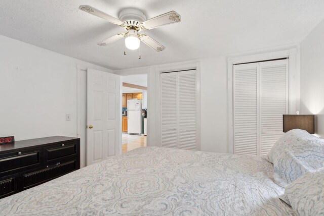 30 Swan Cir, Shapleigh, ME 04076 - bedroom with freestanding refrigerator, multiple closets, and ceiling fan