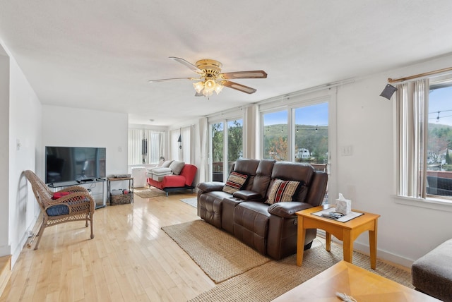 30 Swan Cir, Shapleigh, ME 04076 - living room featuring plenty of natural light, light wood finished floors, a ceiling fan, and baseboards