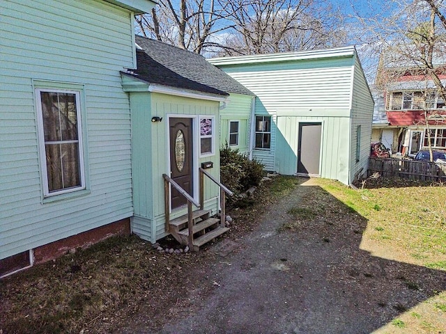 view of front of home with entry steps, board and batten siding, and a shingled roof