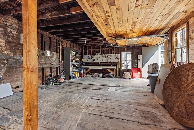 misc room featuring a workshop area and wood-type flooring