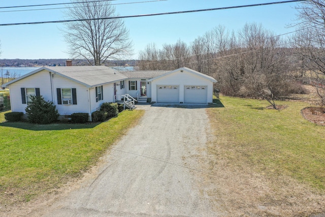 ranch-style home with an attached garage, cooling unit, driveway, and a front yard