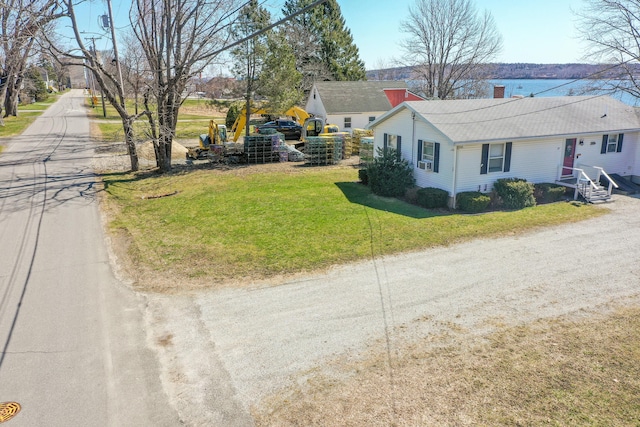 exterior space with a lawn and roof with shingles