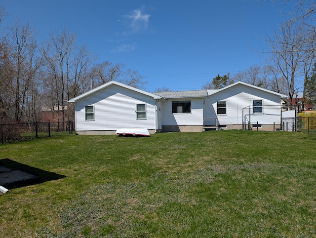 back of house with a lawn and fence