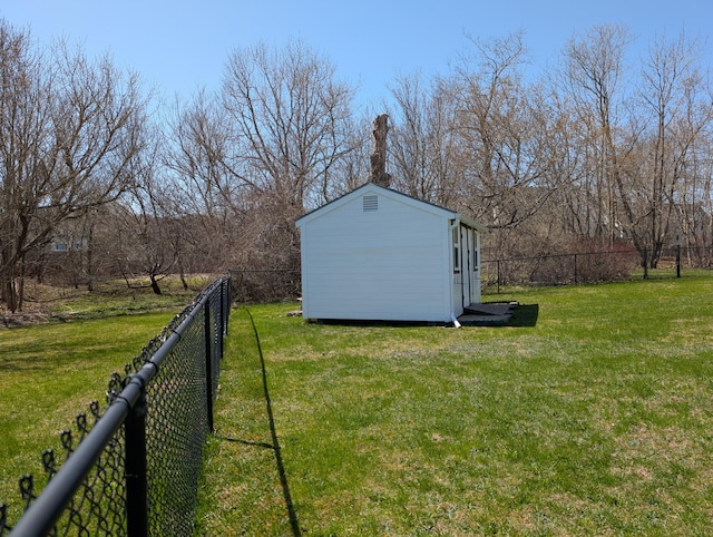 view of yard featuring an outbuilding, fence private yard, and a storage unit