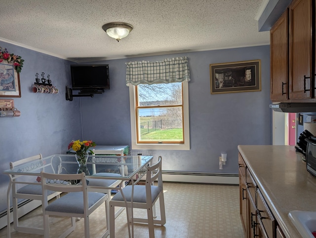 dining area with crown molding, a textured ceiling, and baseboard heating