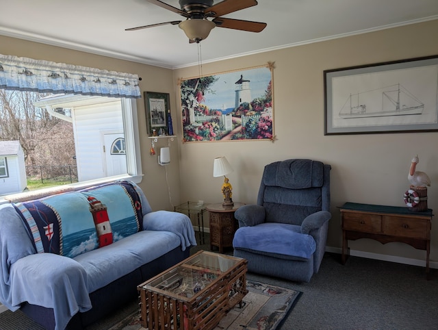 sitting room featuring crown molding, baseboards, ceiling fan, and carpet