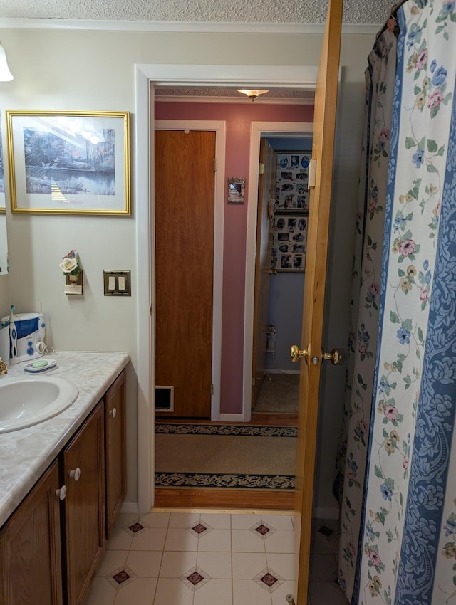 bathroom featuring tile patterned flooring and vanity