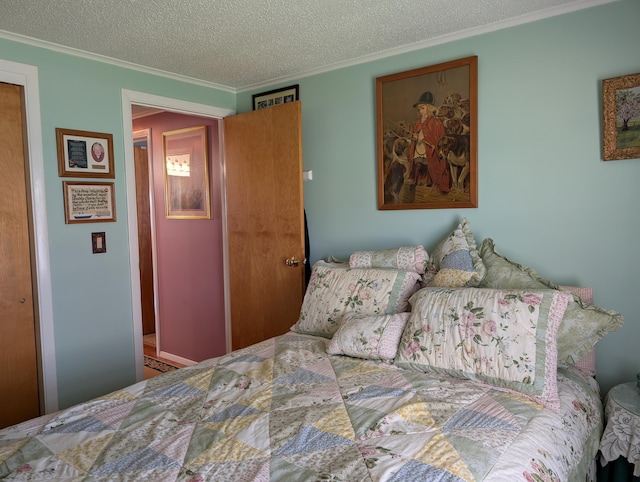 bedroom featuring a textured ceiling and ornamental molding