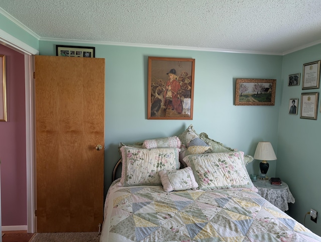 bedroom featuring crown molding and a textured ceiling