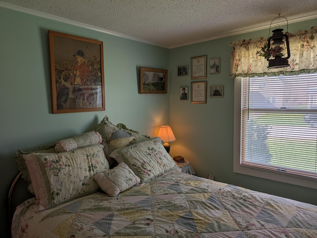 bedroom with a textured ceiling and ornamental molding