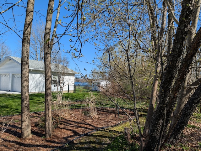 view of yard featuring an outdoor structure and a garage
