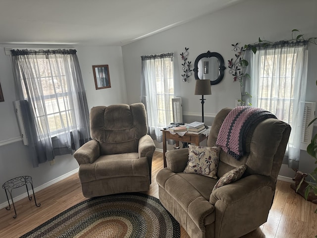 living area with light wood-style floors and baseboards