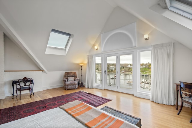 bonus room with wood finished floors and vaulted ceiling with skylight