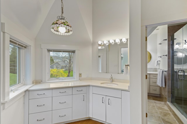 full bath with vanity, a stall shower, and high vaulted ceiling