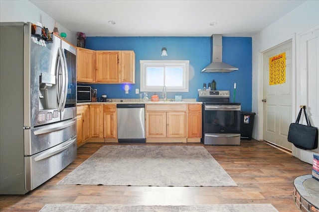 84 Main St, Dixfield, ME 04224 - kitchen with light countertops, appliances with stainless steel finishes, light brown cabinetry, and wall chimney range hood