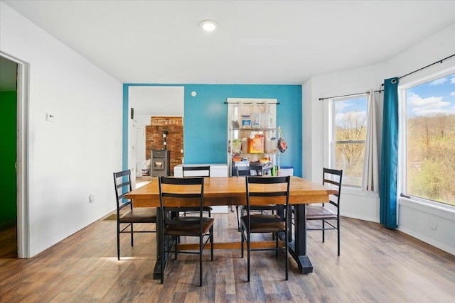 84 Main St, Dixfield, ME 04224 - dining space featuring baseboards, a wood stove, wood finished floors, and recessed lighting