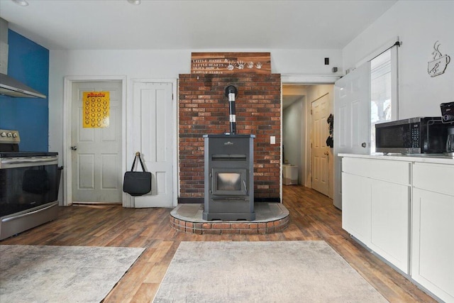 84 Main St, Dixfield, ME 04224 - living room featuring wood finished floors and a wood stove