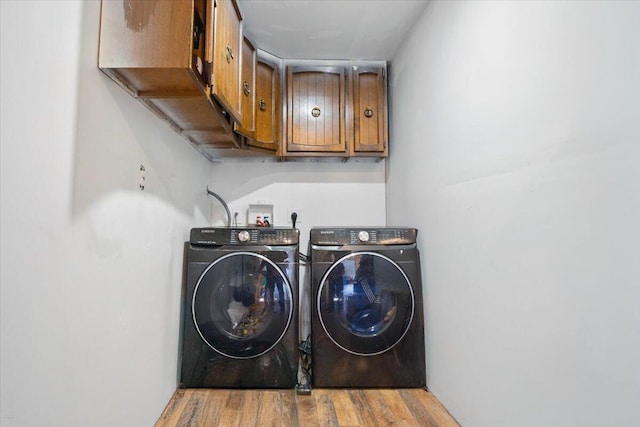 84 Main St, Dixfield, ME 04224 - clothes washing area with wood finished floors, cabinet space, and washer and dryer