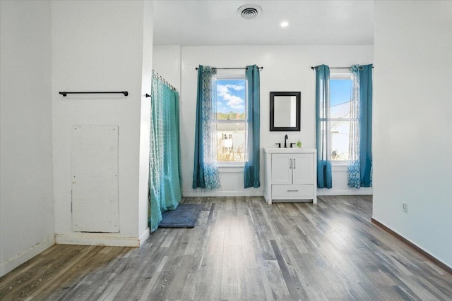 84 Main St, Dixfield, ME 04224 - unfurnished room with baseboards, a wealth of natural light, and wood finished floors