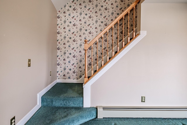 stairway with carpet flooring, baseboards, a baseboard heating unit, and vaulted ceiling