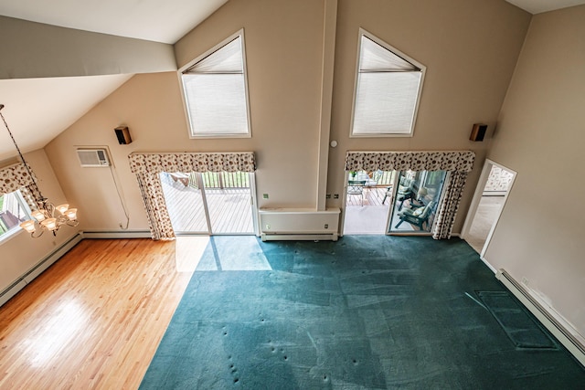 unfurnished living room featuring a baseboard radiator, a wall mounted AC, wood finished floors, and baseboard heating