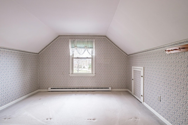 additional living space with lofted ceiling, a baseboard heating unit, and light carpet