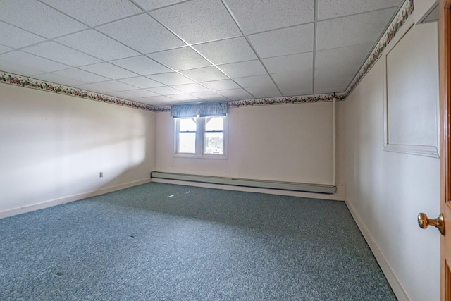 carpeted empty room featuring baseboards, a baseboard heating unit, and a paneled ceiling